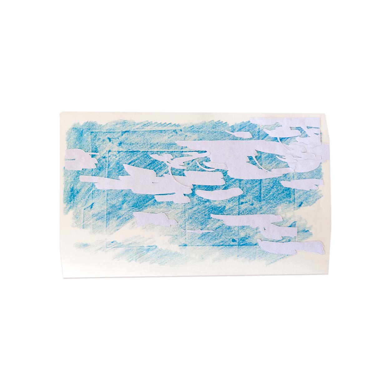 Cutouts of white clouds dance across diagonal streaks of blue colored pencil. The sketch sits on a small piece of off-white paper set against a stark field of white.