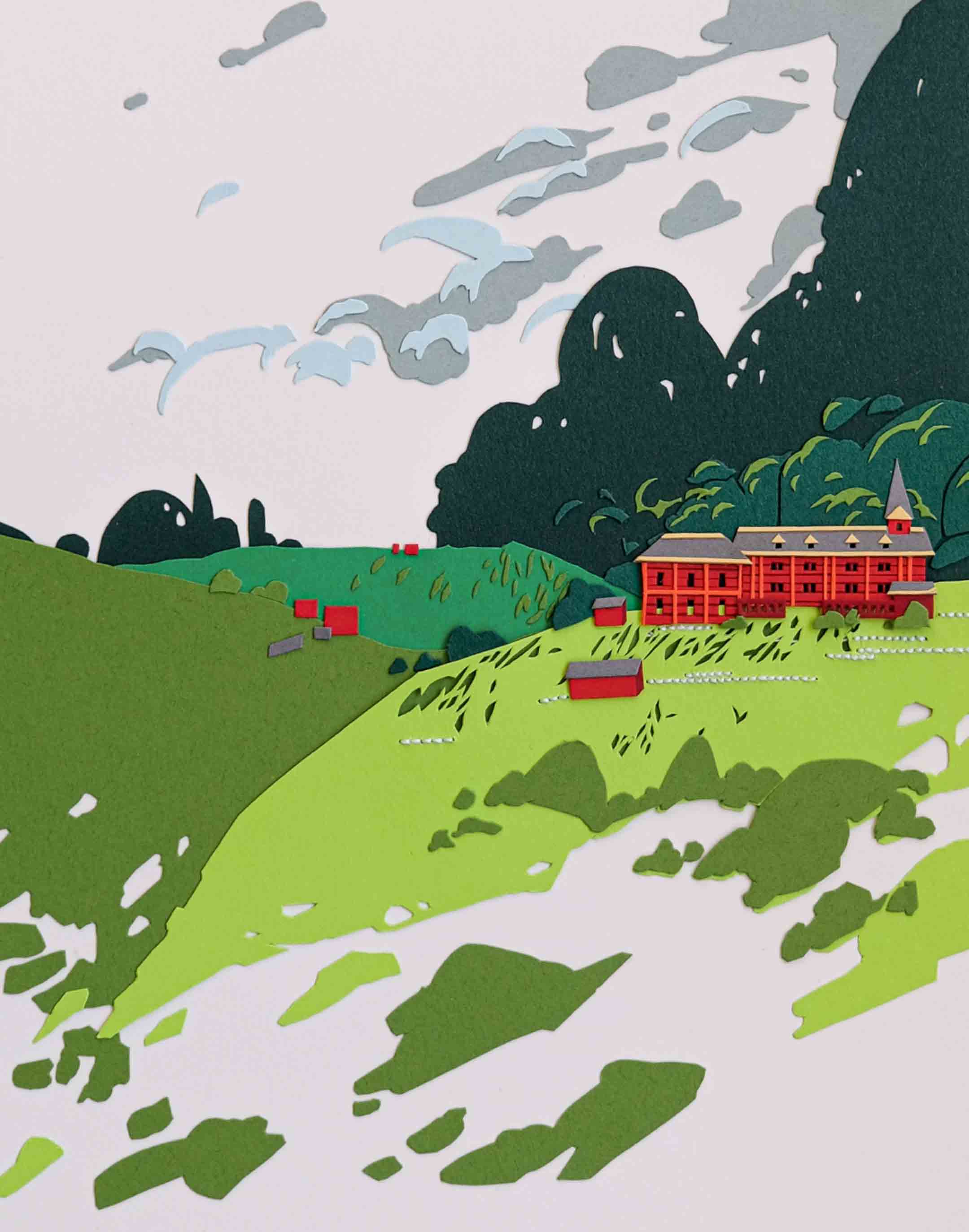 A red paper schoolhouse is surrounded by trees on green hills.