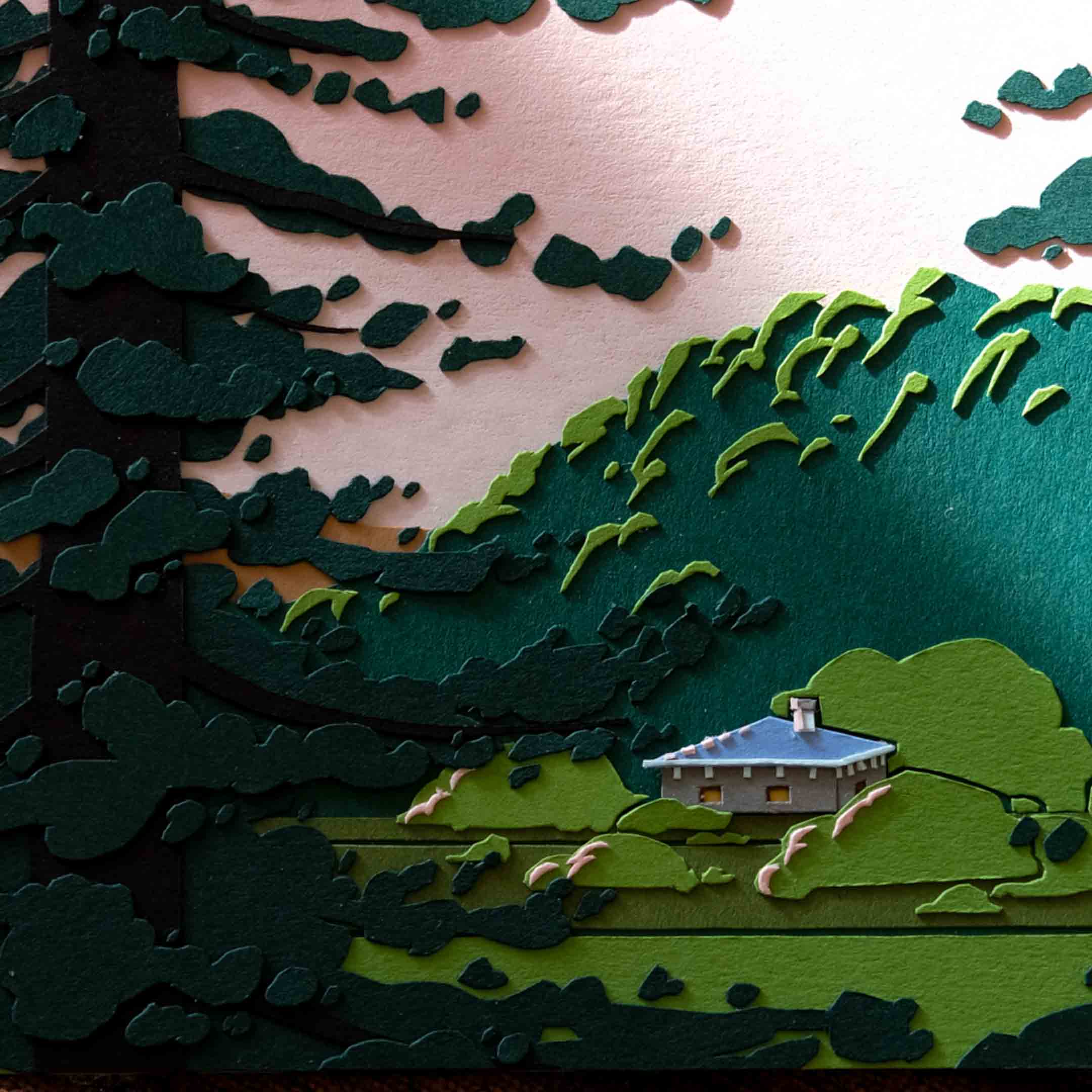 A close-up of the artwork shows the details of gray paper house and the surrounding fields and trees.